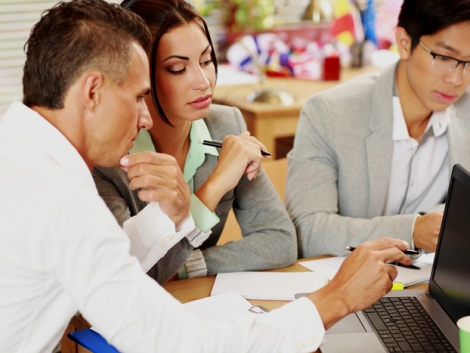 Business people working around table in office