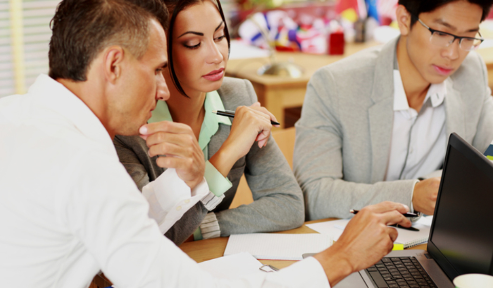 Business people working around table in office